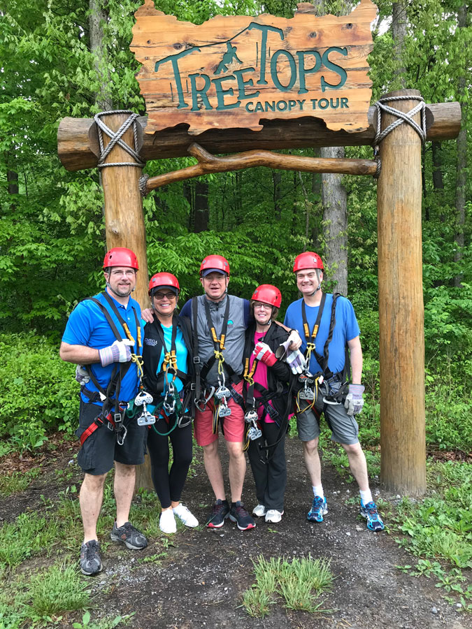 Leon, Peggy, David, LJ and Levi of Omega Commercial Interiors under the Treetops Canopy at the New River Gorge.